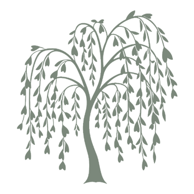 Somatic Guidance & Rest Tarryn DeNolf sitting cross-legged outdoors next to a blooming pink flower bush